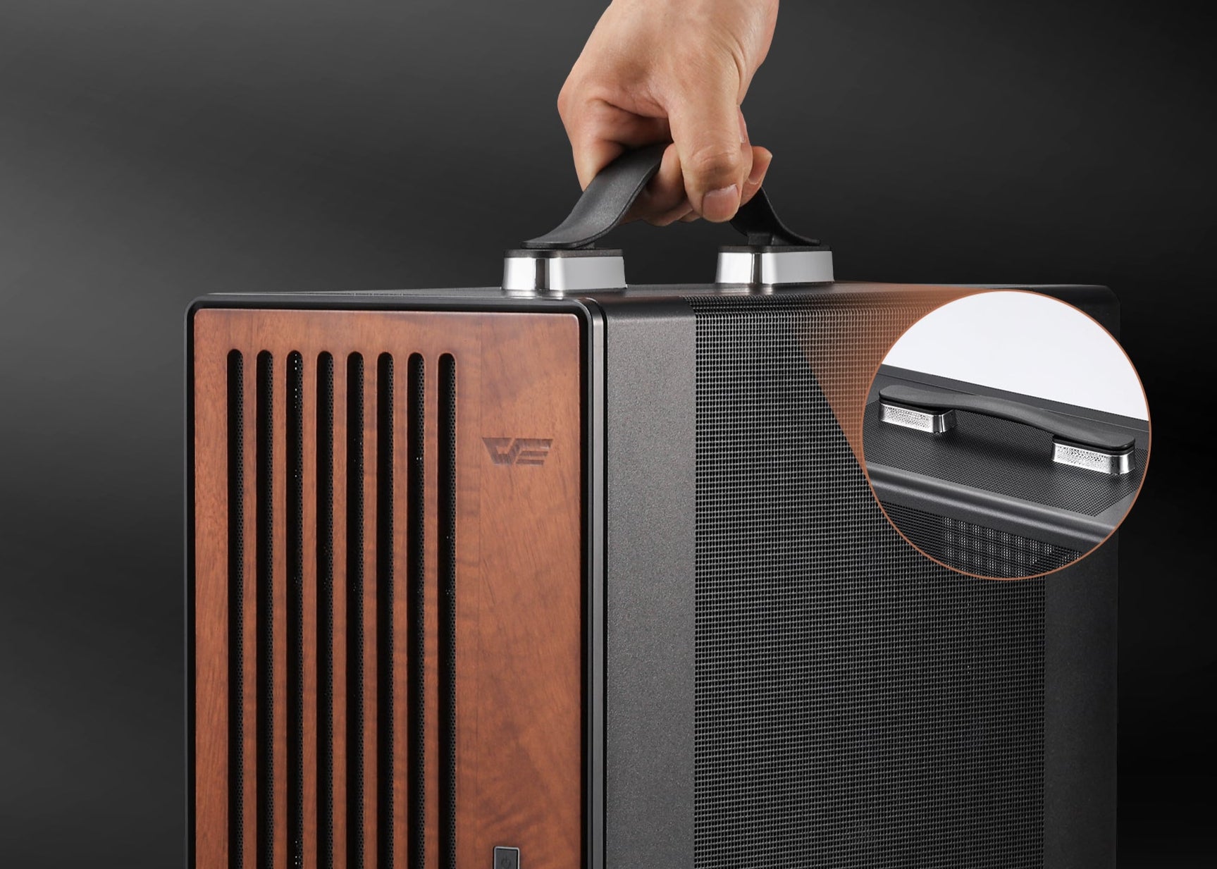 Portable air purifier with wooden front panel and black sides, held by a hand against