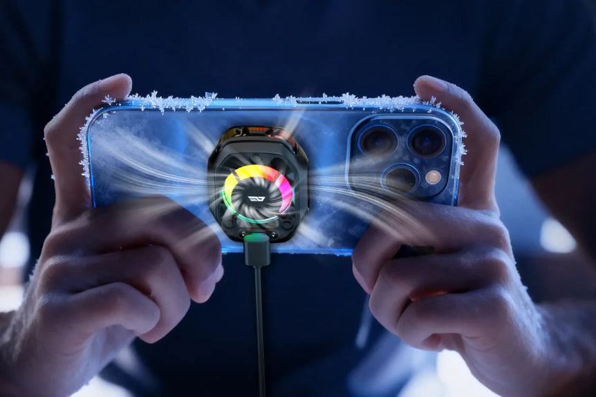Close-up of a person holding a smartphone with a cooling system attached, showing the cooling fan in action.