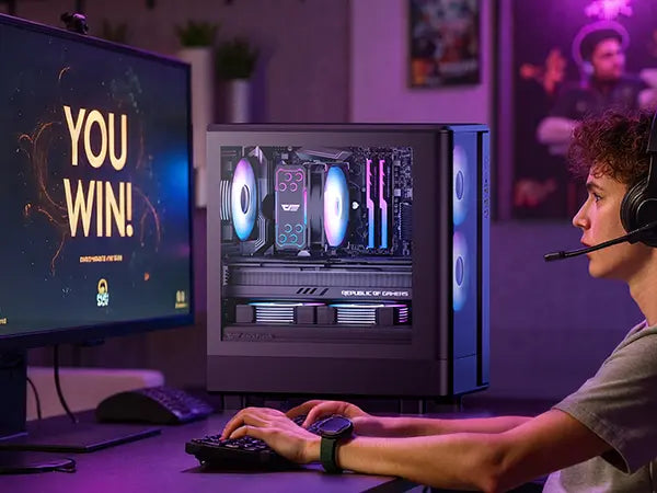 Person playing a video game with a computer setup and YOU WIN!