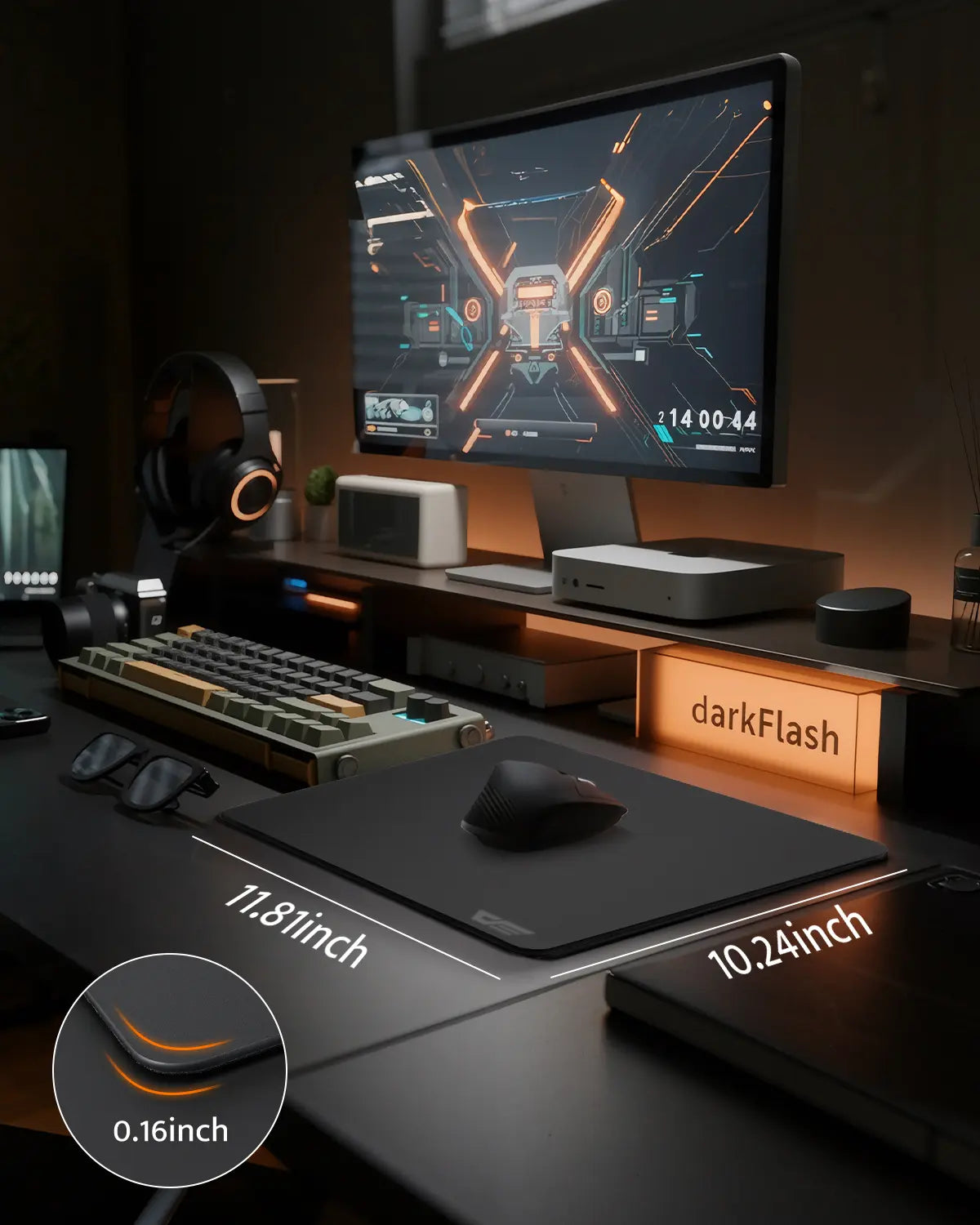 Modern gaming desk setup with computer monitor, keyboard, and mouse on a dark surface.